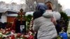 Mourners react by the grave of Russian opposition leader Aleksei Navalny at a Moscow cemetery on March 2. 