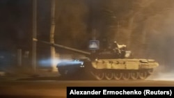 A tank drives along a street in Donetsk on February 22 after President Vladimir Putin ordered the deployment of Russian troops to two breakaway regions in eastern Ukraine following his recognition of their independence.