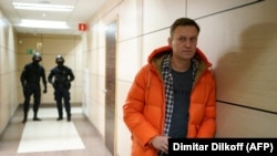 Aleksei Navalny stands in a hallway of a business centerthat houses the office of his Anti-Corruption Foundation in Moscow during a raid by law enforcement on December 26, 2019.