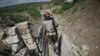 Nagorno-Karabakh -- Ethnic Armenian soldiers walk in a trench at their position near Nagorno-Karabakh's boundary, April 8, 2016