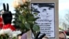 BELARUS -- People flash the V-sign to pay tribute to late opposition protester Raman Bandarenka during his funeral ceremony in Minsk, November 20, 2020