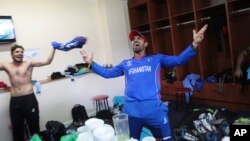 Afghan players celebrate after beating Ireland on March 23.