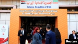 People walk in the entrance of the Iran section of the Baghdad International Fair, in Baghdad, Iraq November 10, 2018. Picture taken November 10, 2018. REUTERS/Thaier al-Sudani