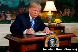 U.S. President Donald Trump signs a proclamation declaring his intention to withdraw from the JCPOA Iran nuclear agreement in the Diplomatic Room at the White House in Washington, U.S., May 8, 2018.