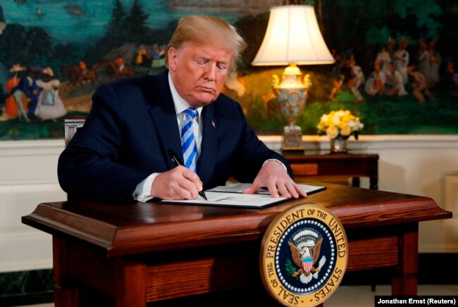 U.S. President Donald Trump signs a proclamation declaring his intention to withdraw from the JCPOA Iran nuclear agreement in the Diplomatic Room at the White House in Washington, U.S., May 8, 2018.