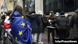 Protesters donned Georgian and EU flags outside the Georgian Foreign Ministry building in Tbilisi on December 2.