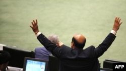 A member of the Iranian Parliament gestures as President Hassan Rouhani (not pictured) speaks in the capital Tehran, on August 28, 2018. It was the first time Rouhani had been summoned by parliament in his five years in power, with MPs demanding answers o