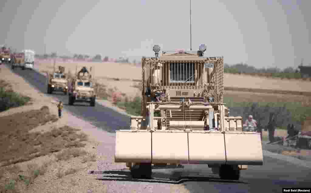 A U.S military demining vehicle leads a convoy near Raqqa in July 2017.&nbsp;