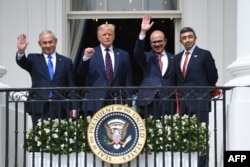 Премьер-министр Израиля Биньямин Нетаньяху, президент США Дональд Трамп, министр иностранных дел Бахрейна Абдуллатиф аль-Заяни и министр иностранных дел ОАЭ Абдулла бин Заид аль-Нахайян машут с балкона в Белом доме после подписания ими "Соглашений Авраама". 15 сентября 2020 года