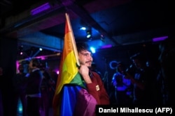 A man tears up at a club in Bucharest as LGBT community members wait for the results of the October 2018 referendum.