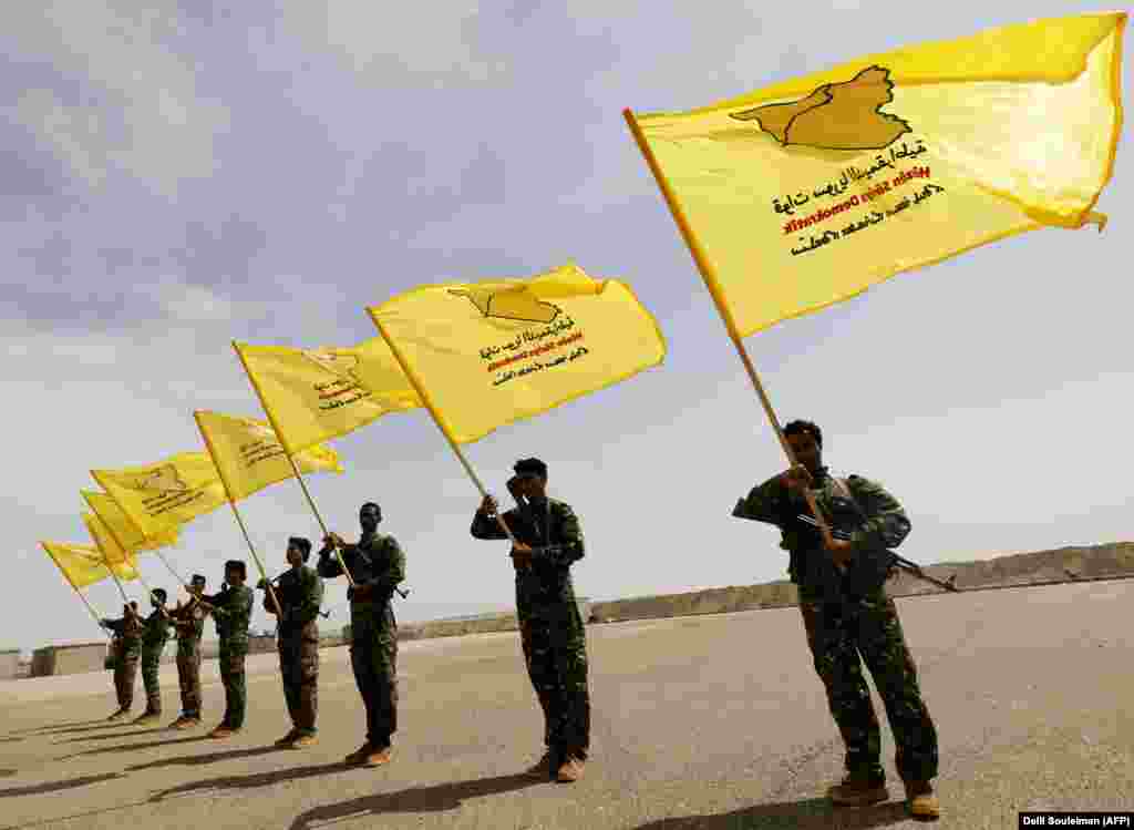 Members of the rebel Syrian Democratic Forces, trained by a U.S.-led coalition, participate in a graduation ceremony for their first regiment in Al-Kasrah, in the eastern Syrian city of Deir Ezzor. (AFP/Delil Souleiman)