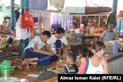 Chewing tobacco is widely available in Central Asia. Here children their brothers pack the product at a market stall in the Kyrgyz city of Osh (file photo).