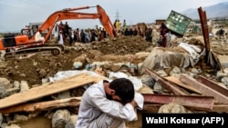 An Afghan villager reacts next to his destroyed house as rescuers search for survivors and bodies after a flash flood hit Parwan Province late last month. 
