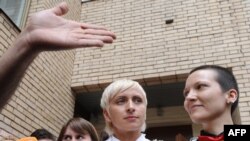 Irina Shapitko (right) and Irina Fedotova-Fet exit a wedding registration office in Moscow on May 12.