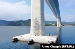 Chinese workers on one of the bridge piers in May 2022.