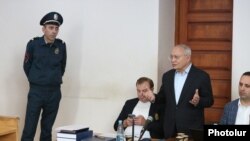 Former Prosecutor-General of Armenia Aghvan Hovsepian (standing) during his trial in a Yerevan court, May 16, 2022.