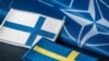 Сьцягі Фінляндыі і Швэцыі на фоне сьцяга NATO