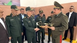 Iran's then-military chief, Mohammad Baqeri, and then-Tajik Defense Minister Sherali Mirzo attend the opening ceremony of the alleged Iranian drone factory in Tajikistan on May 17, 2022. 