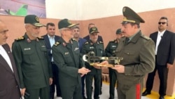 Фармондеҳи пешини артиши Эрон Муҳаммад Боқирӣ (чап) ва собиқ вазири дифои Тоҷикистон Шералӣ Мирзо (рост) дар маросими ифтитоҳи корхонае, ки иддао шуд паҳподи эронӣ тавлид мекунад. Шаҳри Душанбе, 12-уми майи соли 2022