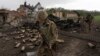 Ukrainian servicemen patrol in a recently retaken village north of Kharkiv on May 15.