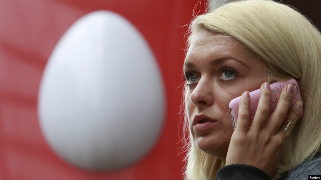A woman speaks on the phone near an office of Russia's mobile phone operator MTS in Moscow. (file photo)