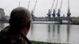 Plauru resident Gheorghe Puflea looks across the Danube at the Ukrainian port of Izmail.