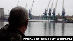 Plauru resident Gheorghe Puflea looks across the Danube at the Ukrainian port of Izmail.