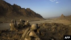 U.S. Marines keep watch on a hilltop during a patrol in Helmand Province on September 21.