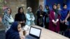 Staffers of the Bamilo online shopping site attend a meeting at their office in Tehran, Iran.May 22, 2017 (AP Photo/Ebrahim Noroozi)
