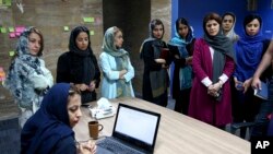 Staffers of the Bamilo online shopping site attend a meeting at their office in Tehran, Iran.May 22, 2017 (AP Photo/Ebrahim Noroozi)