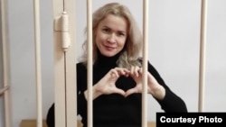 Maria Ponomarenko gestures from a court cell on May 20.
