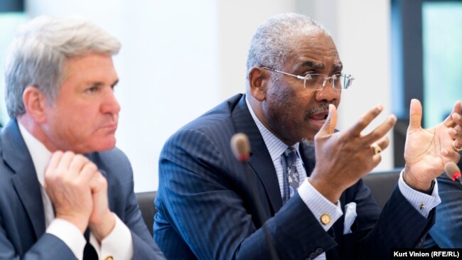 U.S. Representative Gregory Meeks (right) speaks as Representative Michael McCaul (left) listens in Prague on May 25..