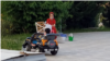 Turkmenistan. Woman with child in the park. Mask. Сhildren's car. Ashgabat. May, 2022