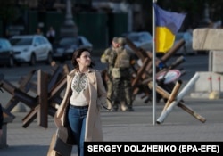 A woman dressed in a vyshyvanka walks through Independence Square in Kyiv.