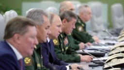 Russian President Vladimir Putin (third left) visits the National Defense Control Center to oversee the test of Russia's Avangard hypersonic missile system, which can carry nuclear warheads, in Moscow in 2018. 