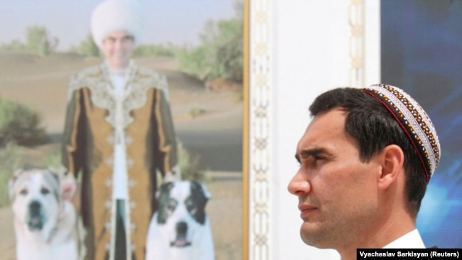 Turkmen President Serdar Berdymukhammedov in front of a portrait of his father, Gurbanguly. (file photo)