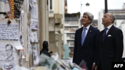 John Kerry and French Foreign Minister Laurent Fabius pay tribute to the victims killed in the attack on the satirical newspaper Charlie Hebdo.