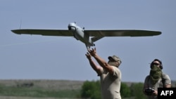 Ukrainian soldiers of the 22nd Brigade launch a Leleka reconnaissance UAV drone near Chasiv Yar on April 27.