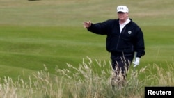 U.S. President Donald Trump walks on the course of his golf resort in Scotland.