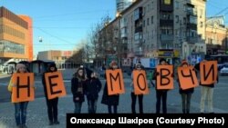 Activists in Dnipro, Ukraine's fourth-biggest city with about 1 million people, hold single-letter posters on November 24 that spell out, "Don't be silent," to protest violence against women.