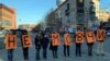 Activists in Dnipro, Ukraine's fourth-biggest city with about 1 million people, hold single-letter posters on November 24 that spell out, "Don't be silent," to protest violence against women. 