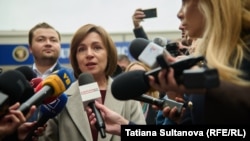 After casting her ballot, President Maia Sandu said by voting today Moldovans "can preserve peace and stability" in the tiny country, adding, "Moldovans must determine their own destiny" without "lies and dirty money."