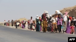 Displaced Iraqi families from the Yazidi community cross the Iraqi-Syrian border at the Fishkhabur crossing, in northern Iraq, on August 13. 