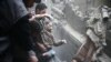 A man in eastern Ghouta is helped after a bombing attack in the Syrian region.