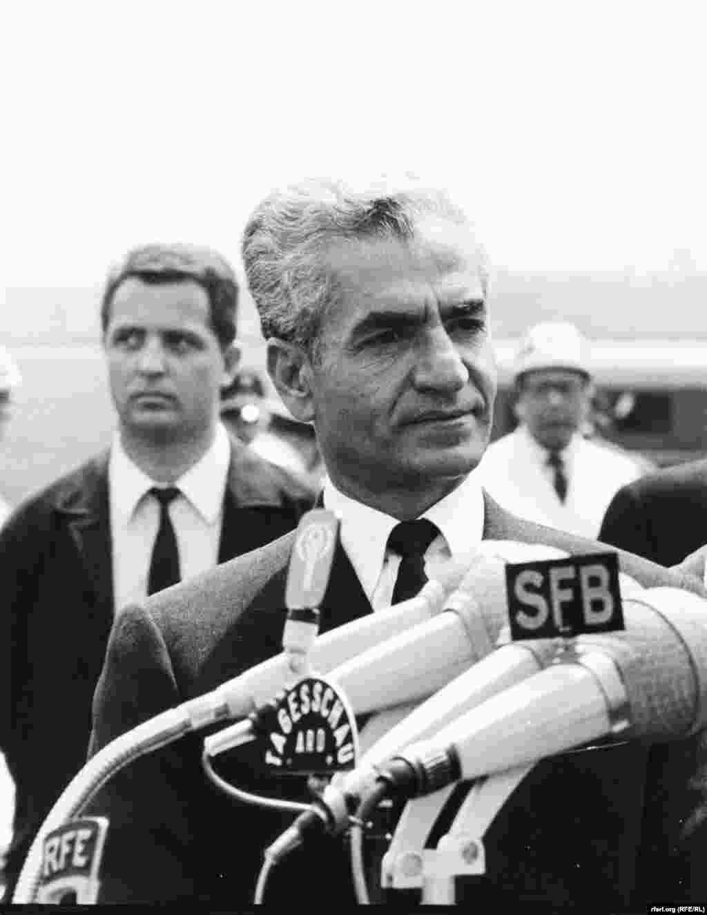 The shah of Iran speaks into an RFE microphone during a 1968 diplomatic trip to Berlin.