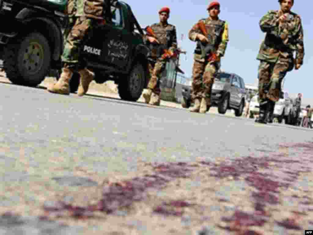 Violence inceases in Afghanistan. - Afghan National Army (ANA) soldiers arrive as they walk a road with blood at the site of a suicide attack in Kabul on May 29, 2008. A suicide attacker blew up a car bomb near a US-led coalition convoy in Kabul on May 29, causing no serious injuries to the troops but killing three Afghan civilians, police and the coalition said.