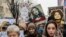 Kosovo -- Women hold posters as they take part in a march  for women's rights and freedom in solidarity with the march organised in Washington, on January 21, 2017 in Pristina.  Hundreds of thousands of protesters spearheaded by women's rights groups are 