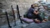 A Syrian rebel fighter mans a checkpoint in the northern city of Aleppo on August 20. 