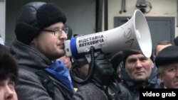 A protester speaks to the crowd at a rally in Kyiv for the release of the last detained "Euromaidan" demonstrator, Yaroslav Prytulenko.