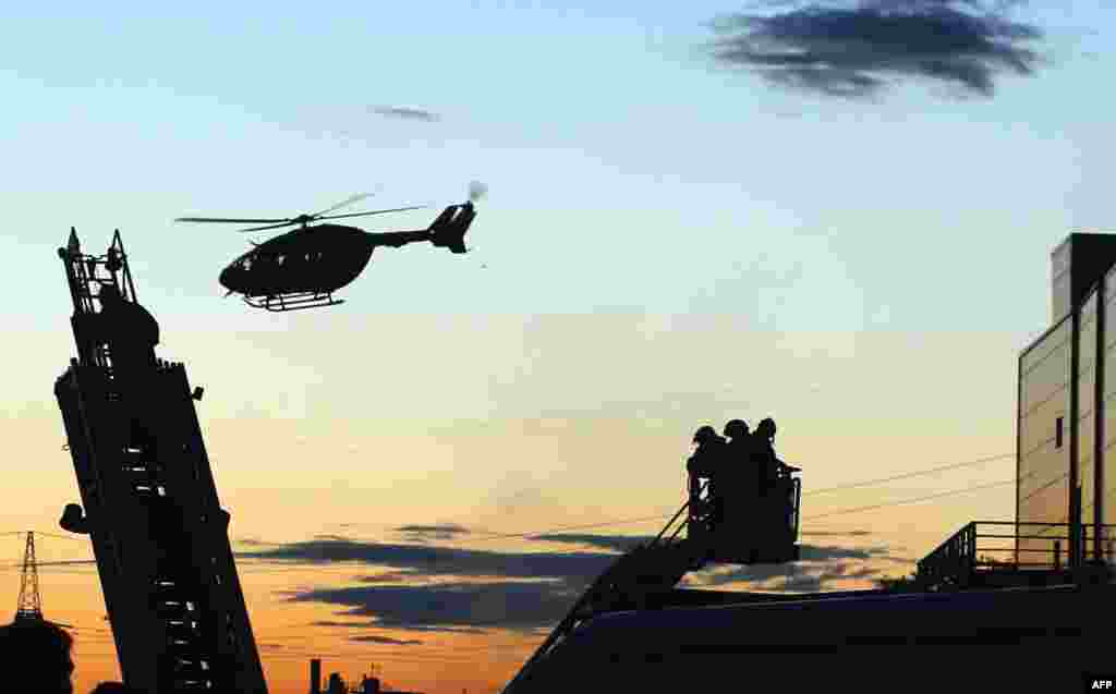 A helicopter flies above Moscow's Rio shopping mall following a fire there on July 10 that injured more than a dozen people. (AFP/Maxim Zmeyev)
